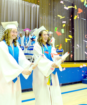 CLASS OF 2024 GRADUATES, Katelynn Post and Claire Plumer celebrate in style, shooting confetti into the air as they were exiting the Stockton High School Commencement held in Tiger Gymnasium last Saturday afternoon.