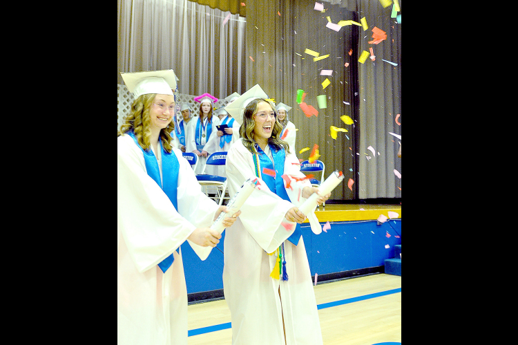 CLASS OF 2024 GRADUATES, Katelynn Post and Claire Plumer celebrate in style, shooting confetti into the air as they were exiting the Stockton High School Commencement held in Tiger Gymnasium last Saturday afternoon.
