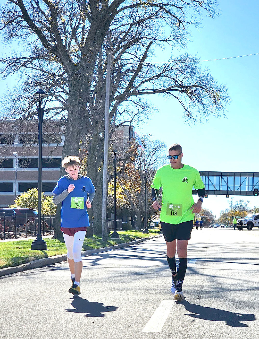 CAMERON LINDSEY, left, keeps stride during the marathon race with the help from pacer Scott Binkley, right. Submitted Photo