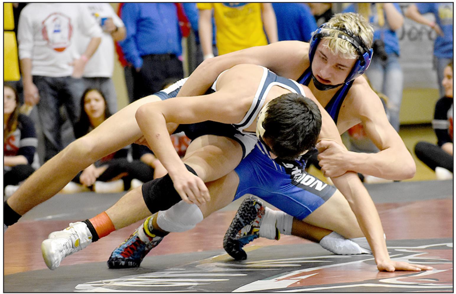 JUSTIN KNOLL makes a move on Adam Reed of Minneapolis during state wrestling action at Gross Memorial Coliseum in Hays on Friday. (Photo courtesy of Bobbi Basart)