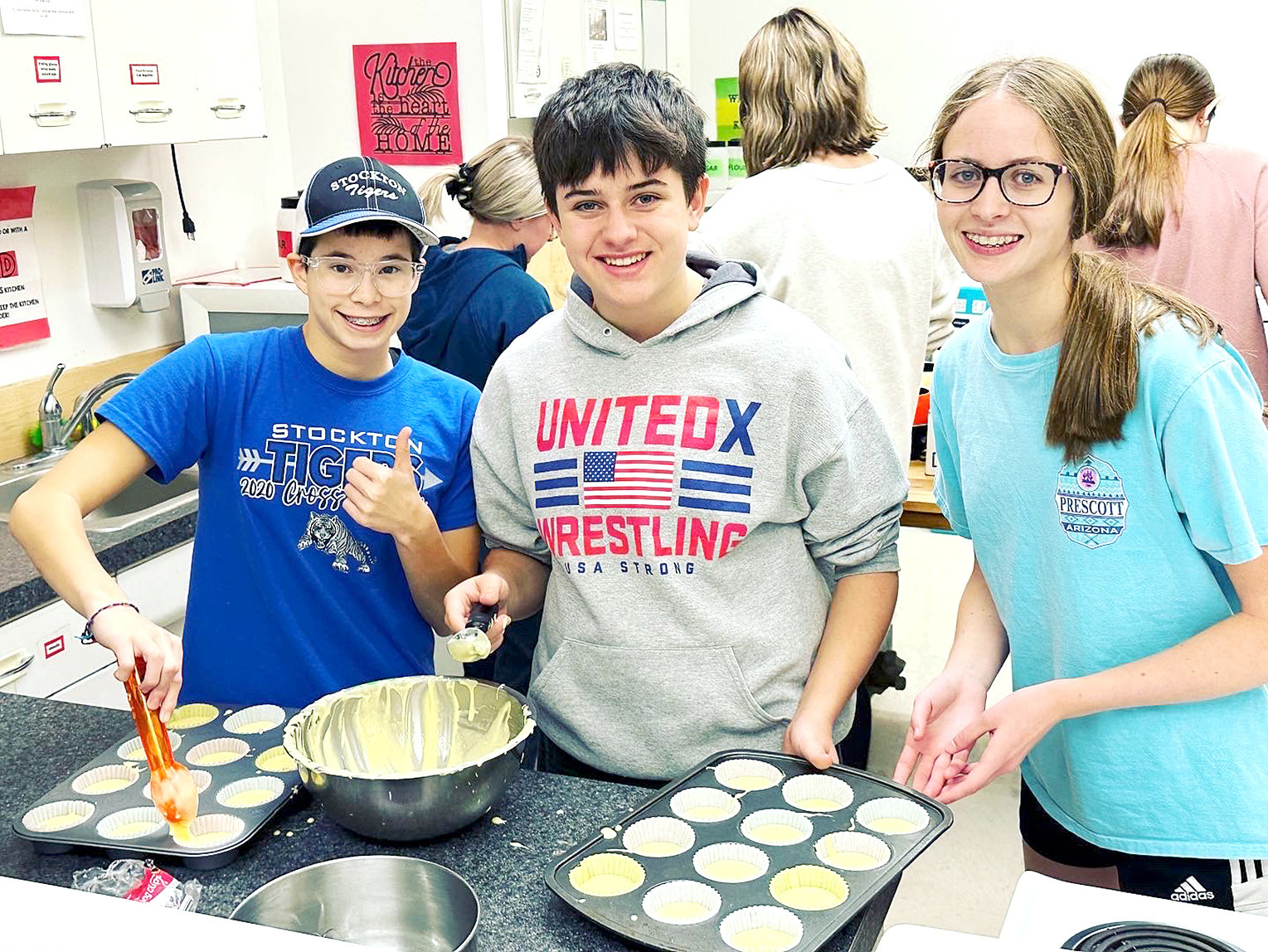 CAROLINA NORTHUP, Keslie St. Clair and Cheyenne Hoeting bake cookies to deliver to the teachers during the KAY Club Citizenship Week as part of Serve the School Day.