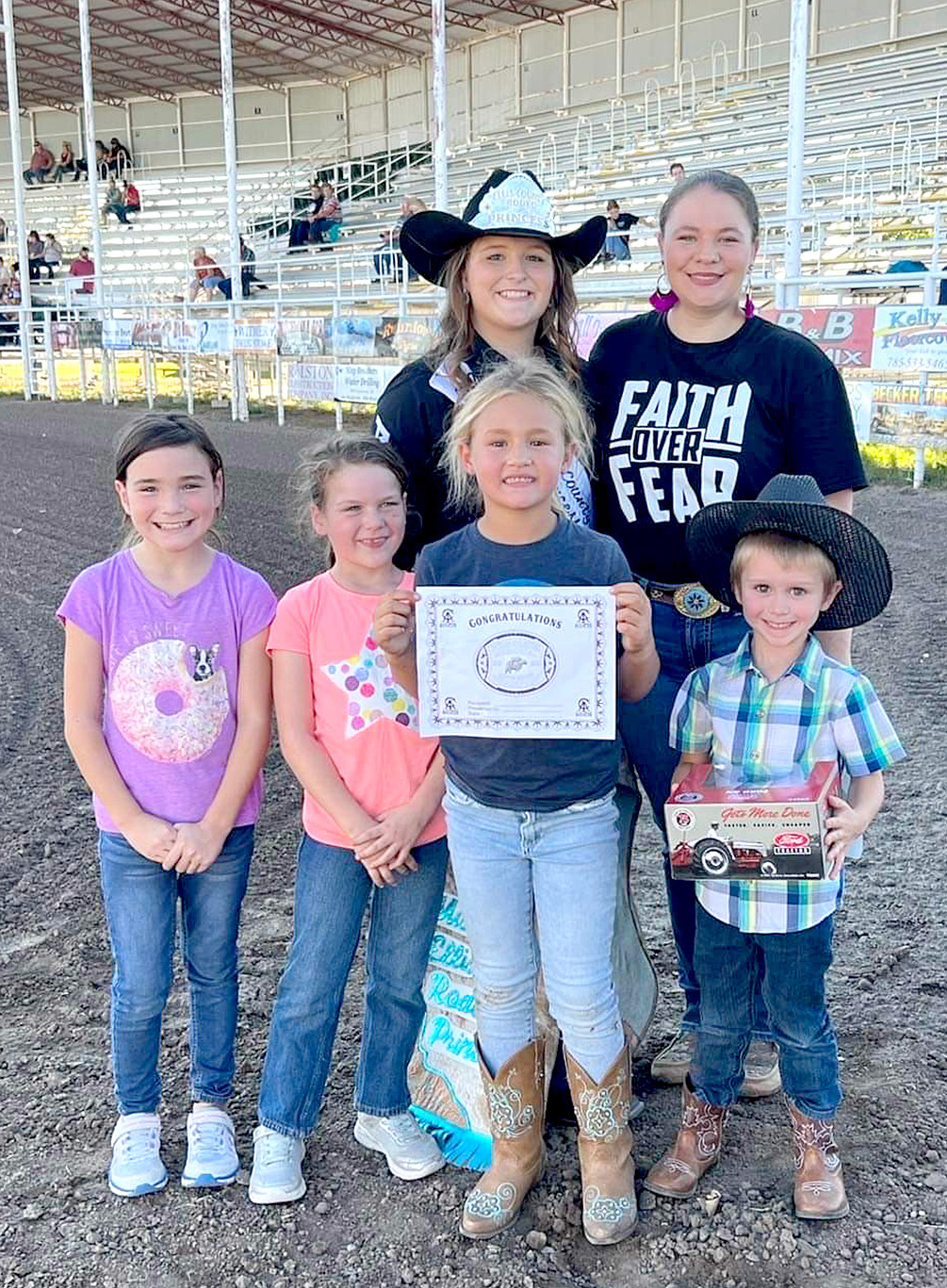 TAKING HOME THE BUCKLE in the mutton busting competition at the Richard Schleicher Memorial Bull Riding event held on Saturday, September 24th was Alynn Bouchey. Pictured are (front row, from left): Maddy Swaney, Jessa Swaney, Alynn Bouchey, Matthew Reiner; (back row) Ellis County Rodeo Princess Skylar Amlong and Cheyene Carlson.