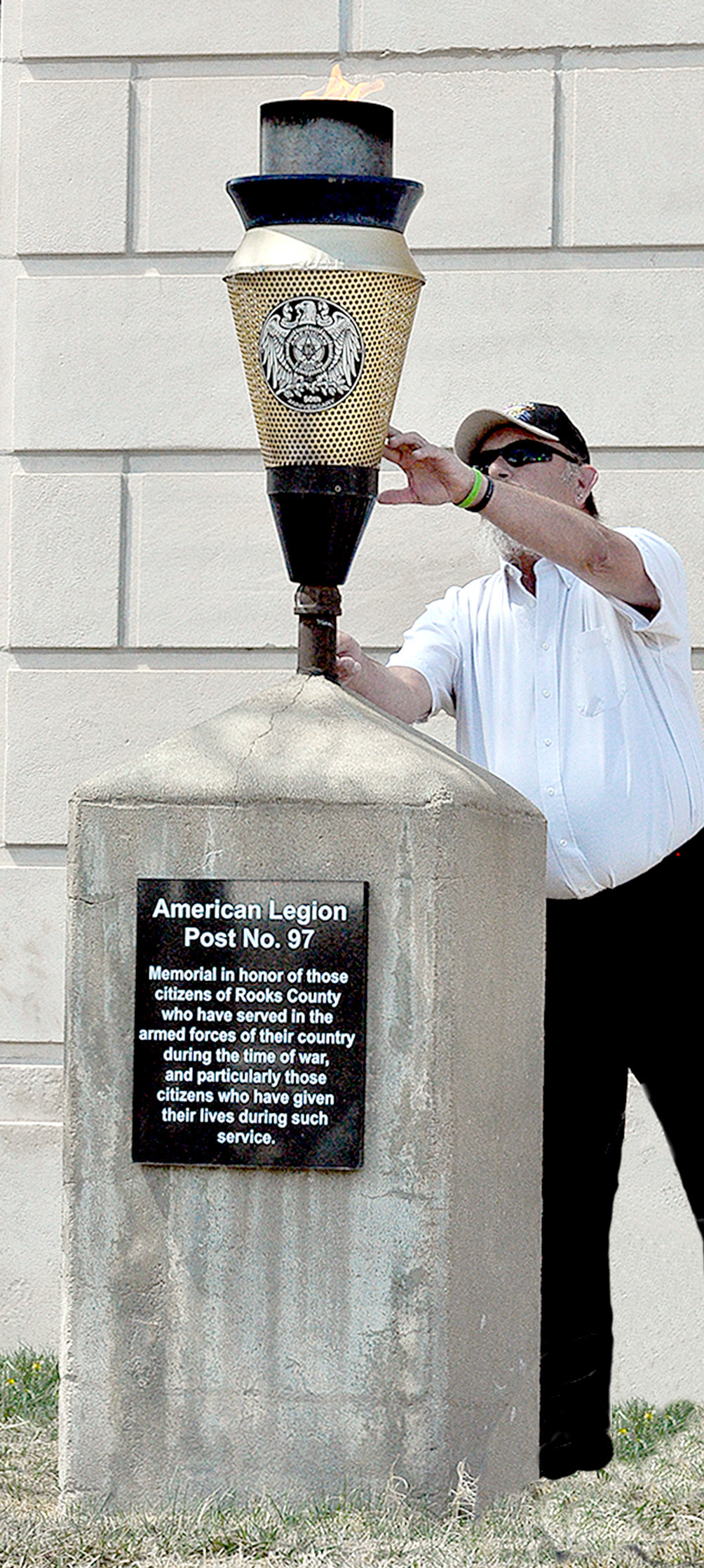 AMERICAN LEGION POST NO. 97 COMMANDER Mack Palmer lights the eternal flame during the Centennial Celebration of the Rooks County Courthouse on Thursday, April 20th. The Post installed the eternal flame in honor of the Rooks County citizens who served in the armed forces.