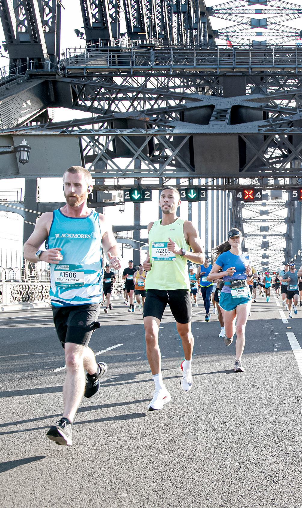 TRENTON MILLER (middle), along with the other Sydney Marathon runners, ran across the world’s largest steel arch bridge, the Sydney Harbour Bridge, during the endurance run in Sydney on September 18. Miller, who was in Australia on business, not only participated in the marathon, but qualified himself for the Boston Marathon by running a time of 2:58:42. Miller finished 108th in the pack of 3,450 runners from all around the world. (Photo Courtesy of USA Basketball)