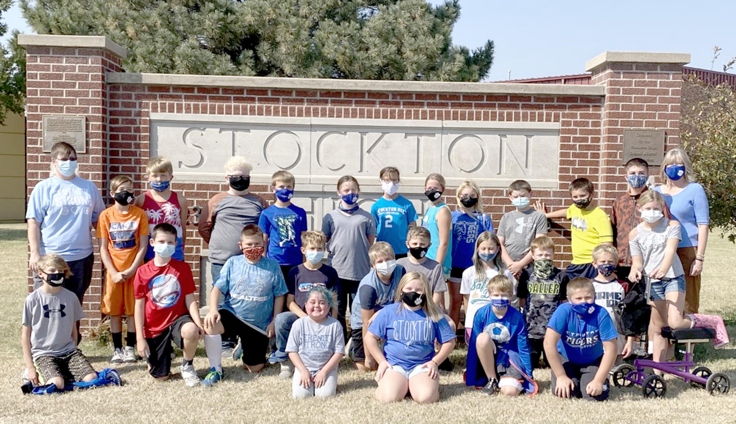 THE FIFTH-GRADE CLASS, with teachers Andrea Dix (far left, back row) and Heather Stamper (far right), surrounds Serenity (front row, center) with their love and support.
