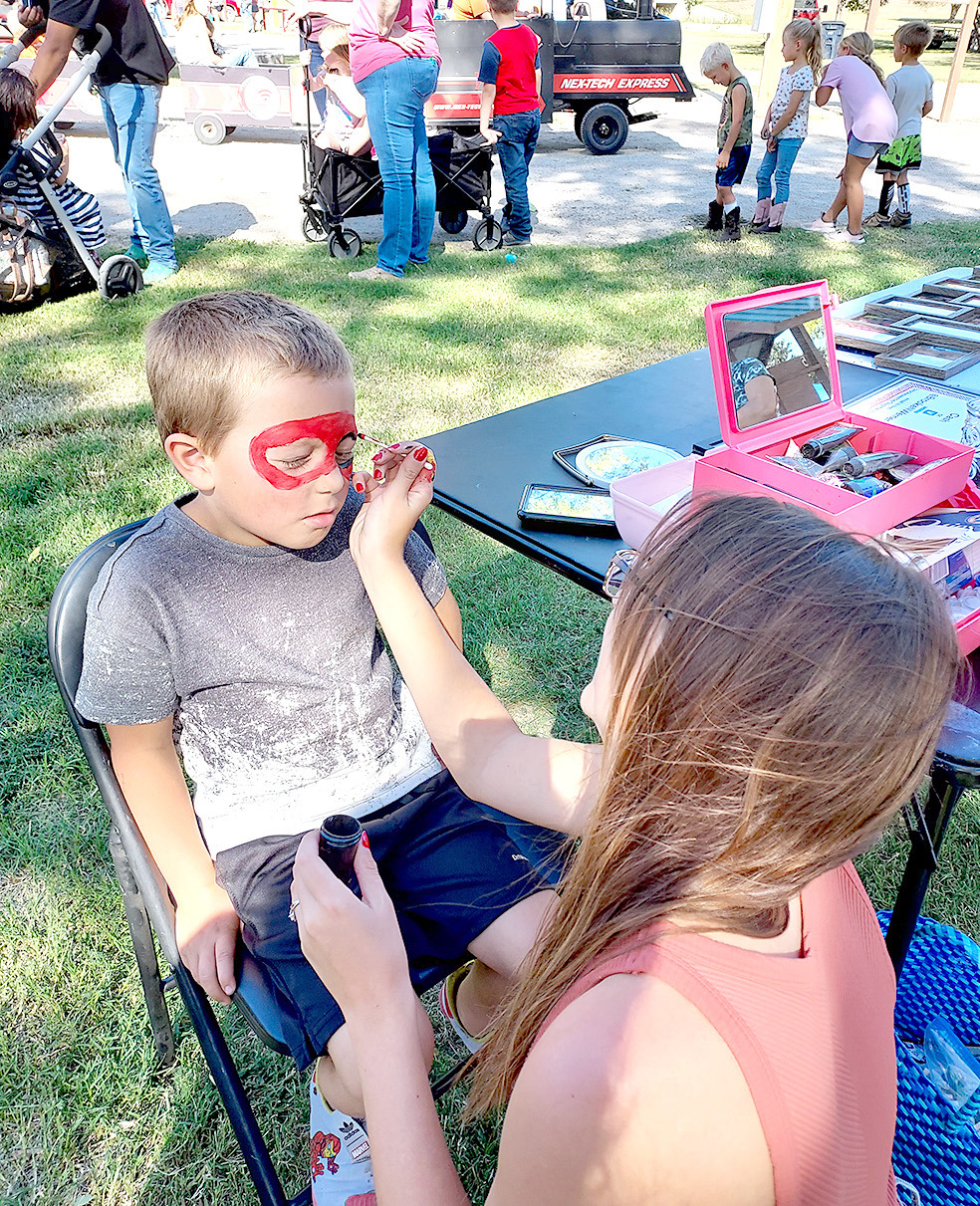 THE FACE PAINTING at the Stockton Pumpkin Patch was Mne of the many popular booths at the event. Getting his Spiderman mask on Ryker States.