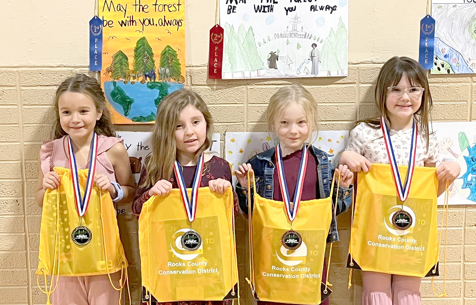 SECOND-GRADE POSTER WINNERS (l to r)—1st, Delaney Lawver, Sacred Heart; 2nd, Presley Pfaff, Plainville; 3rd, Kambree Benoit, Damar; and 4th, Laci Younger, Plainville.