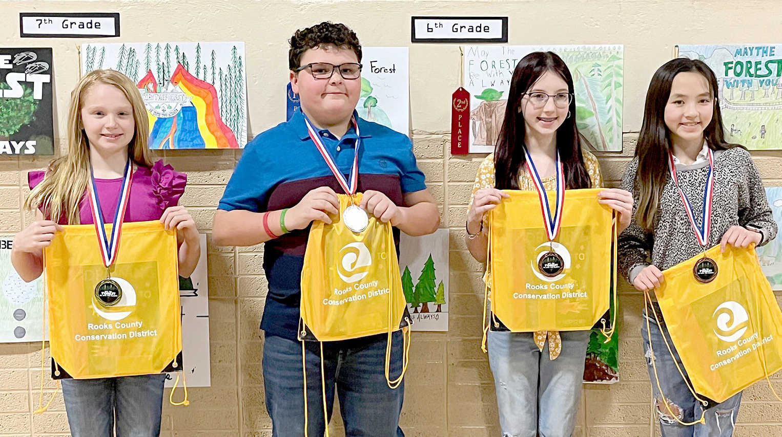 SIXTH-GRADE POSTER WINNERS (l to r)—1st, Daylen Beesley, Palco; 2nd, Liam Balthazor, Plainville; 3rd, Eliza Rudman, Plainville; and 4th, Hartley Takaishi, Plainville.