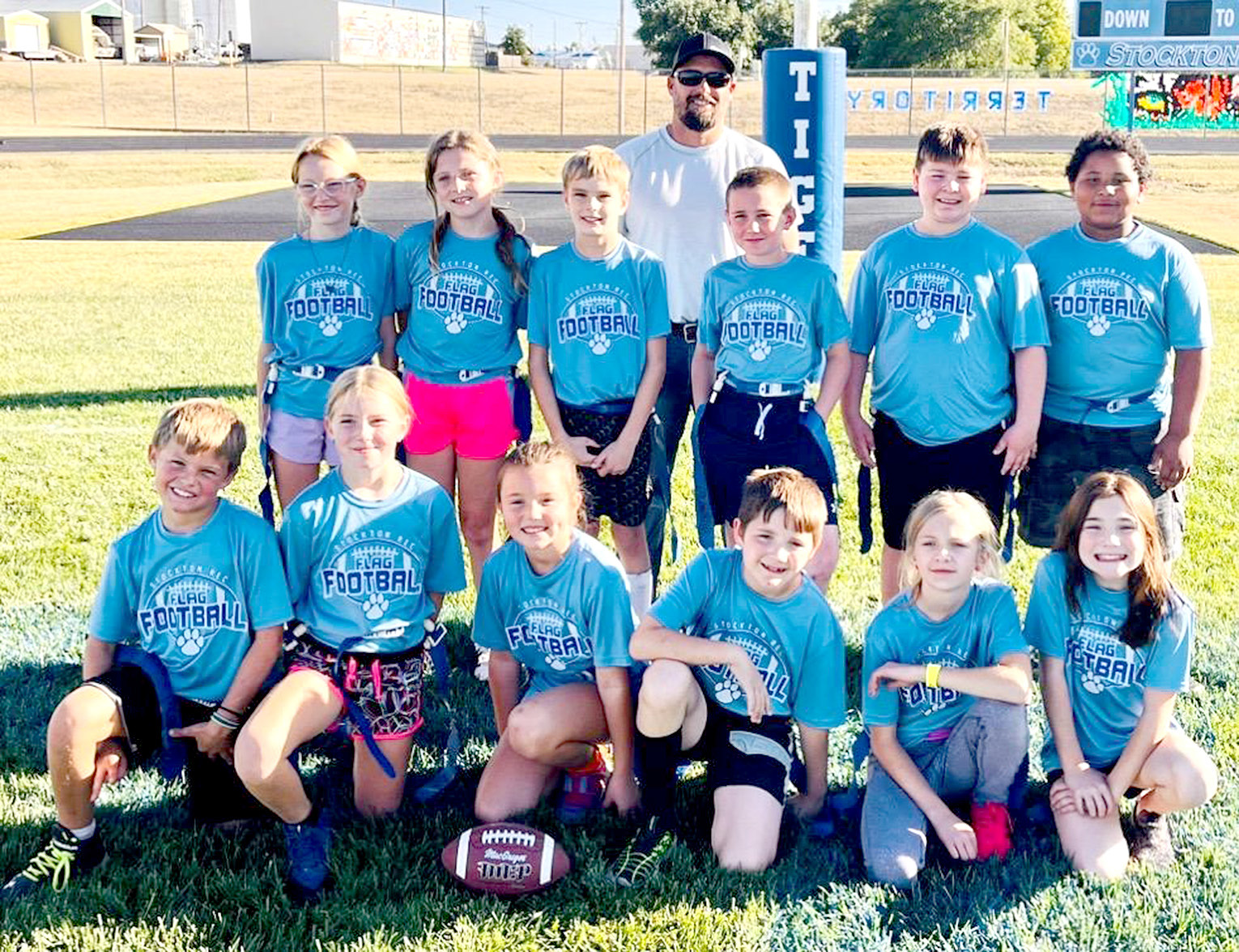 PARTICIPATING in the fourth and fifth-grade Stockton Recreation Flag Football this season were (front row, from left) Cohen Muir, Joree Dibble, Cambry Glendening, Levi Holsinger, Alexandria Eck, Madelyn Swaney; (middle row) Evelynn Hilbrink, Ava Armstrong, Henry Berkley, Hudson Saaranen, LJ Kibbee, Kaiden Fast; (back row) and coach Heath Muir. (Missing from the picture are Emery Peterson and coach Clint Armstrong.