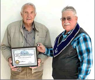 BOB HAMILTON (left) receives his 60-year pin for his years of membership in the Masonic Lodge. Making the presentation is Paradise Lodge # 290 Chaplain Darrell Rubottom, Woodston. Bob joined the Newahcuba Lodge #189 back in December of 1959 here in Stockton. The lodge was disbanded many years ago, and members were transferred to the Paradise Lodge in Plainville.