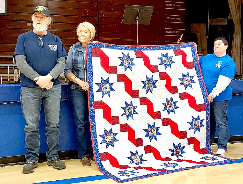 PRESENTED with his Quilt of Valor from by Janie Lowry during the Veterans Day program at Stockton High School was Scott Baker (Army). Pictured are Scott Baker, Janie Lowry and Dena Bouchey.