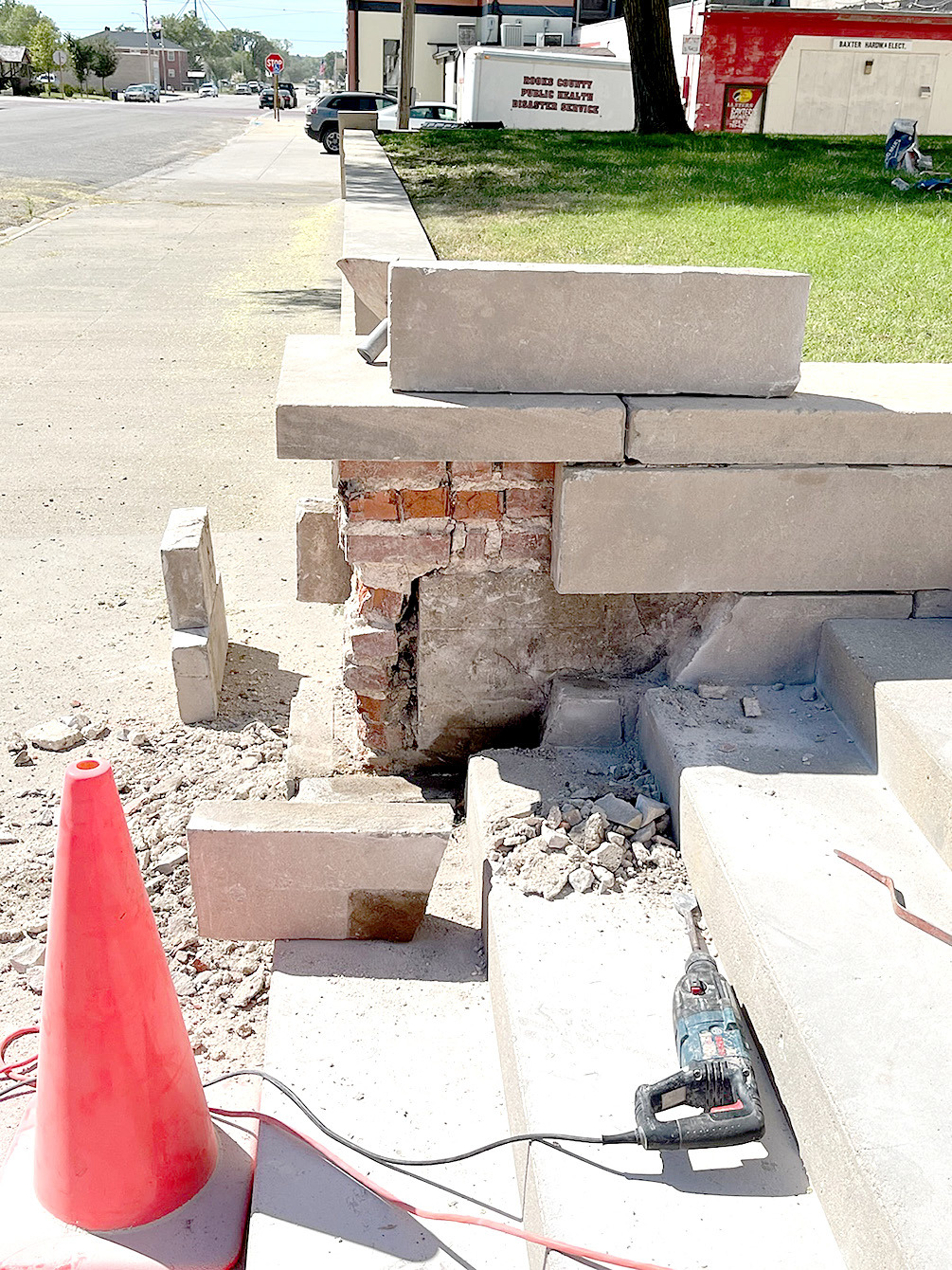 ONE OF THE MANY REPAIRS being done at the Rooks County Courthouse is to the stone wall and steps going into the building. Jakob Stockton reconstructed one of the pillars by taking it apart and setting the stones back in place and filling in the missing pieces.