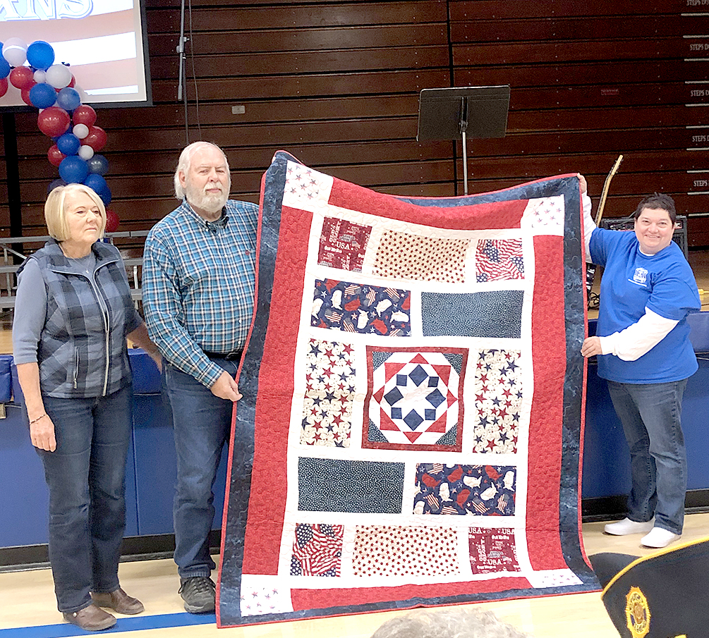 GERALD WEHRLI (Navy) was presented with his Quilt of Valor made by Janie Lowry at the Veterans Day program held on Friday, November 11th. Pictured are Janie Lowry, Gerald Wehrli and Dena Bouchey.