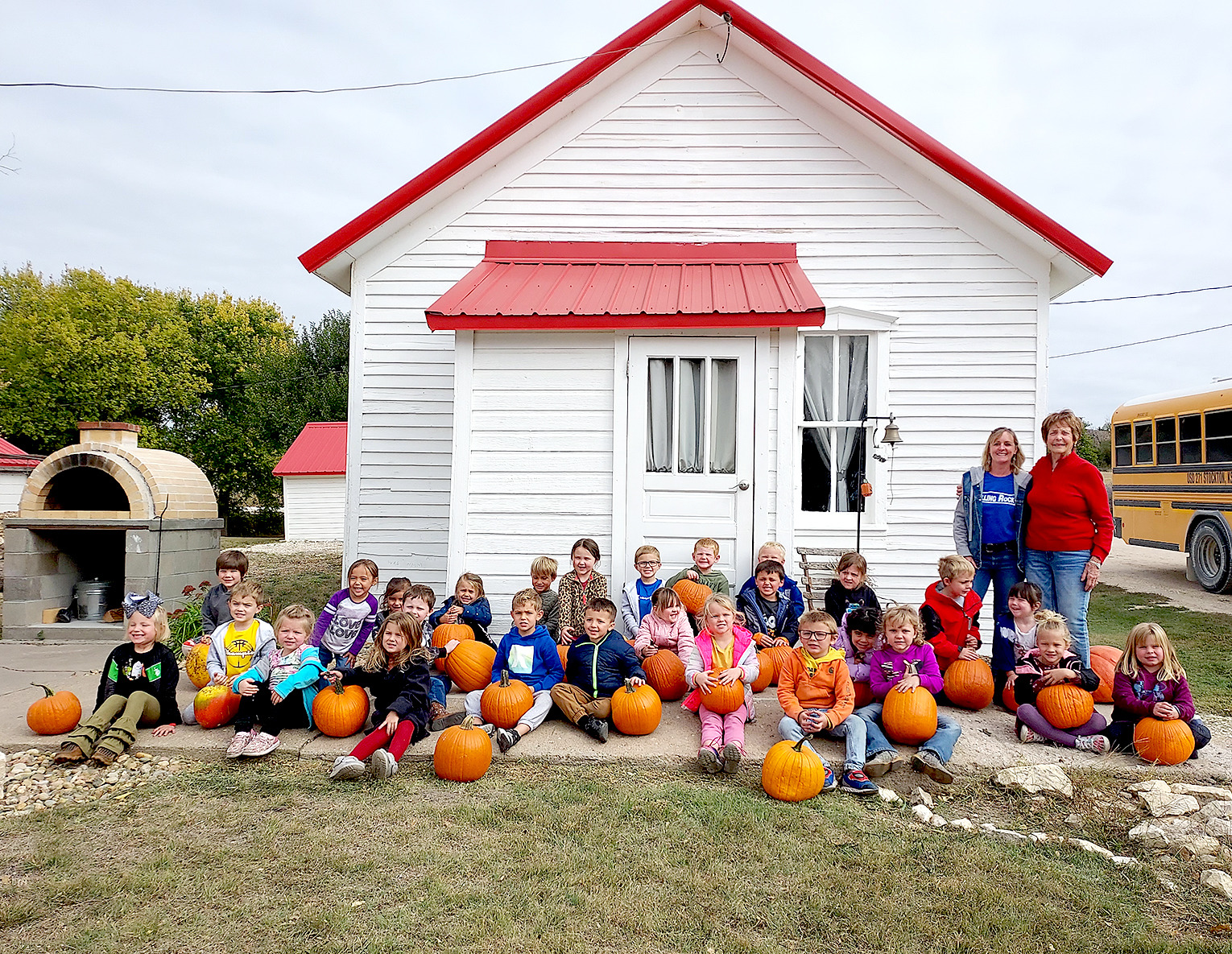 THE STOCKTON THREE- AND FOUR-YEAR-OLD CLASSES of Mrs. Beth Hazen and Mrs. Christine Hamel enjoyed a day at the Prairie View schoolhouse at the O’Grady farm. They learned about what life was like attending a one-room schoolhouse and also enjoying a trip to the pumpkin patch. The two ladies standing to the right are Dawn O’Grady and Joan Balderston.