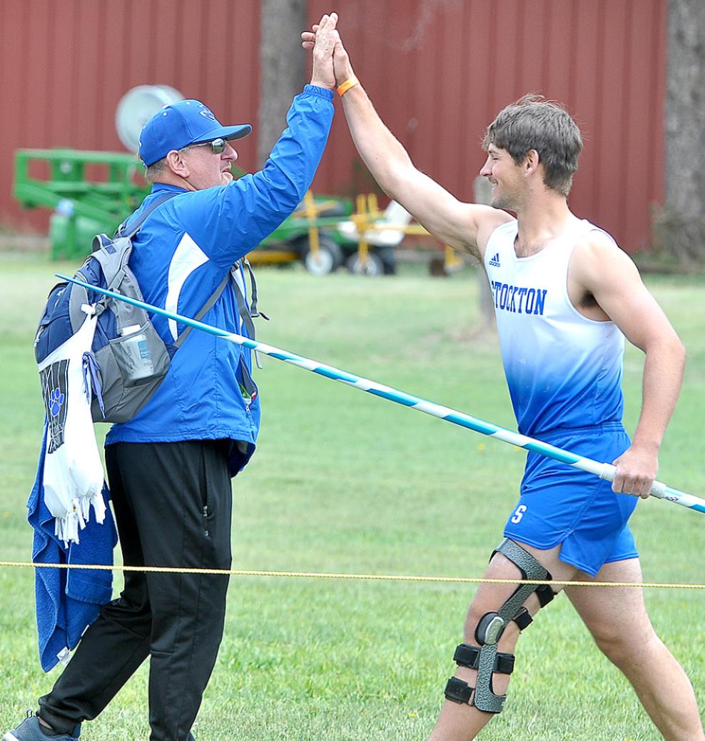 ATTABOY! Rylan Basart receives a high five from his dad and track coach, Justin Basart, after throwing the javelin 182’ at Regionals in Colby. The distance won him a gold medal.