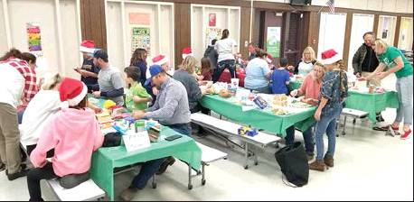 SEVERAL FAMILIES took part in the Gingerbread Family Night on December 5th, a fun addition to the Christmas season. Each family used graham crackers, frosting and their choice of edible decorations to create a Christmas scene. It was a Holly, Jolly time!