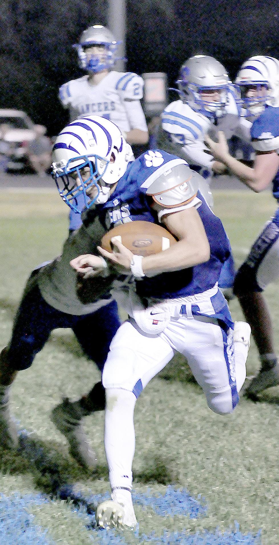 LEIGHTON COLBURN carries the ball across the goal line for a Tiger touchdown in their game against Spearville last Friday.