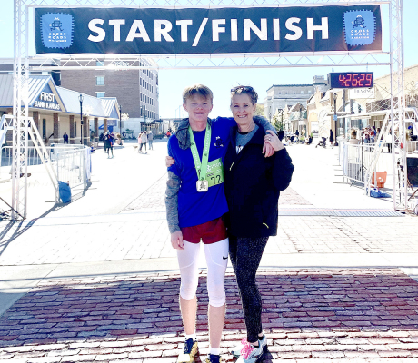 ROOKS COUNTY TEENAGER CAMERON LINDSEY, left, stands with his mom, Shannon, after he recorded a time of 4:25.34 in the Crossroads Marathon in Salina as the youngest finisher. Submitted Photo.