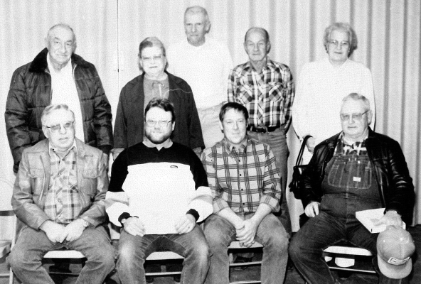 RECOGNIZED FOR THEIR TEN YEARS OF SERVICE in March of 1989 were Rooks County employees (front row, from left): Normand Hrabe, Rick McLaughlin, Kenton Miller, Gerald McLaughlin; (back row) Clarence Hageman, Mrs. Florence Wallis, Eugene Breckenridge, Bill Peacock, and Frances Austin.
