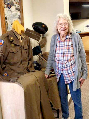EDNA MCCALL stands by her late husband Bob McCall’s World War II uniform and other artifacts donated to the Rooks County Historical Museum. Corporal Robert McCall’s items were displayed in the Museum’s lobby over the Memorial Day Weekend.