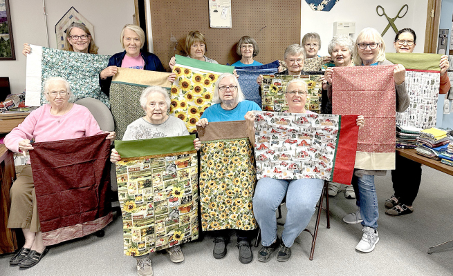 THE CROSSROAD QUILT GUILD MEMBERS made 83 pillowcases as a community service project. The Guild will present the pillowcases to the Solomon Valley Manor in Stockton and Redbud Village in Plainville. Pictured are (front row, from left) Kenda Ross, Janice Miller, Jackie Wright, Linda Stamper; (back row) Betty Bedore, Janie Lowry, Shirley Brungardt, Linda Gardner, Arlene Stramel, Nikki Meistrell, Karen Baldwin, Toni Anderson, and Connie Hasselhorst.