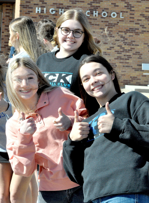 FOUR THUMBS UP! Brooke Kephart, Brin Muir, and Bodye Stithem give the thumbs up to the Lady Tiger wrestlers who qualified for State, during the send-off held for them on Tuesday, February 21.