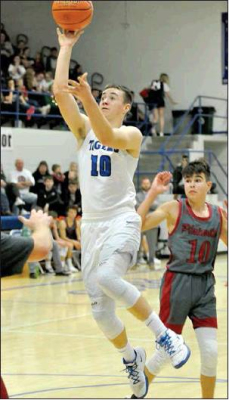 ETHAN MEANS SINKS A FLOATER for two of his 19 points against the Plainville Cardinals last Friday night at Stockton.