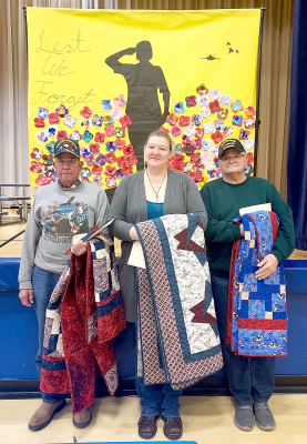 VETERANS Kerry Maddy (Air Force), Jessica Pulec (Army), and James Lewin (Navy) received Quilts of Valor at the annual Veterans Day program held at Stockton High School on Friday, November 10th.