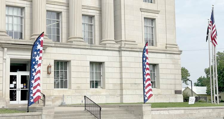 THE PATRIOTIC FLUTTER FLAGS make an attractive entrance to the historical Rooks County Courthouse. Different flags will be rotated throughout the year to enhance the outside of the building.