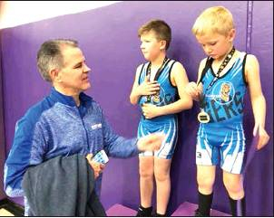 BROTHERS GARRISON (LEFT) AND GRAYSON MONGEAU both started the kids wrestling season strong, as Grayson placed 1st and Garrison, 2nd, at the Christmas Classic Tourney in WaKeeney. Coach Kent Hahn is pictured at left.