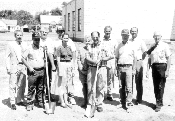 SEVERAL GATHERED for the groundbreaking ceremonies at the proposed site of the new middle school building in the Fall of 1993. Pictured from left are: architect Fred Abercrombie, Harry Colburn, Bill Schmitz, Eldon Kriley, Lois Gasper, Linda Yohon, Scott Ross, Rusty Hrabe, Don Sayer, superintendent Jim Deines and grade school principal Francis Mahoney.