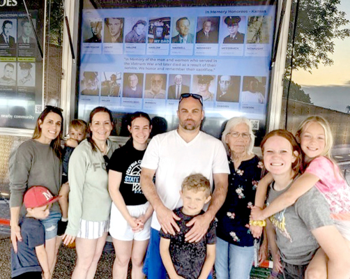 GATHERING AT THE WALL were (from left): Savannah Wilson holding Kyler, Brody standing in front of Savannah, Shannon Glendening, Jory Glendening, Walter Lowry with Kasyn Lowry, Rebecca Lowry, Emma Glendening, and Adrenna Lowry. Also attending, but not pictured, were Muriel and Herbert Morgenthaler.