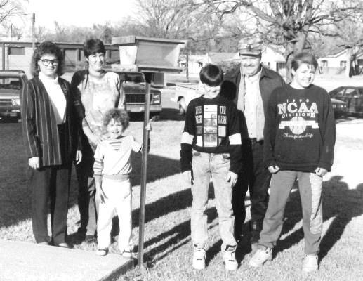 THIS BOY SCOUT PROJECT of a bird feeder placed outside the Solomon Valley Manor was completed in February 1991. Present for the presentation picture were (from left) Solomon Valley Manor Administrator Kris Glendening, scoutmaster Linda Hagan, Katie Hagan, boy scout C. J. Hagan, Department of Wildlife Assistant Manager Don Jenkins, Jr., and boy scout Craig Sammons.