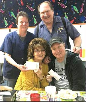 BILL AND DIXIE DIBBLE OF 183 LANES held a benefit bowling tournament on September 28, to help defray medical expenses for Mike and Connie Stithem (seated) and are pictured presenting them with the funds. The tournament drew 58 sets of Doubles participants!