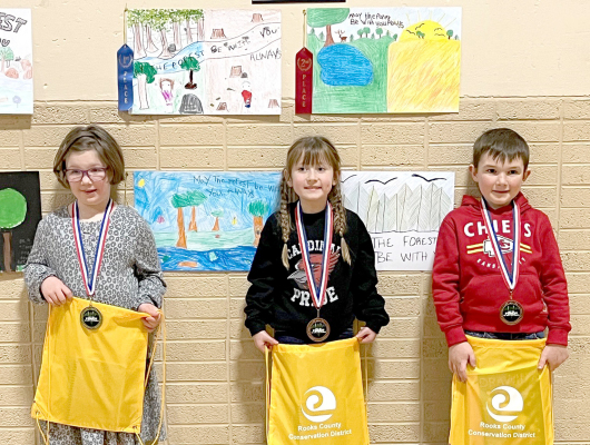 KINDERGARTEN POSTERWINNERS (l to r)—1st, Alivia Reilly, Damar; 3rd, Jessah Slaubaugh, Sacred Heart; and 4th, Cooper Tremblay, Sacred Heart. Not pictured is 2nd-Place Winner Bryadon Parson, Sacred Heart.