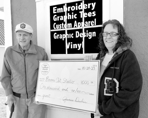 JAMES DESBIEN with the Damar Community Foundation presented Michelle “Missy” Boone with a check for $1,000 for her new business, Boone Art Studio.