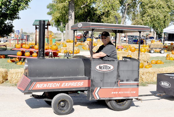 KATHY CREIGHTON enjoyed getting to be the conductor of the Nex-Tech train during last weekend’s Pumpkin Patch.