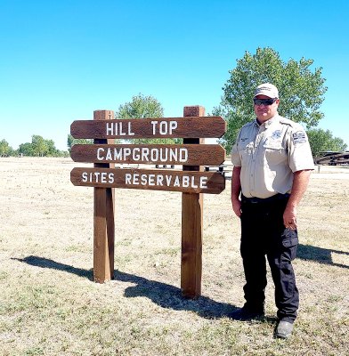 WEBSTER STATE LAKE PARK MANAGER ZACH KESLER stands by the Hill Top Campground, which was designed and built from the ground up, for the campers to utilize and enjoy a wonderful view of the lake during their weekend trips.