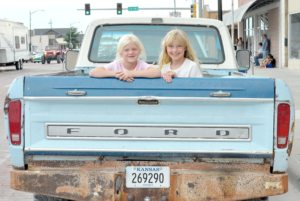KENDRA (6) AND CALIA (8) PETERSON enjoyed a portion of Cruise Night from the bed of a 1979 Ford Pickup on Friday evening. They are the daughters of Myles and Carrie Peterson of Sioux Falls, SD, and the granddaughters of Gary Peterson of Stockton.
