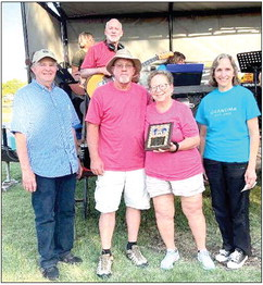 NATOMA LIONS TERRY TUCKER (far left) and Corinne Masters (far right) presented Shawna Dunlap (center) with the Natoma Good Citizen Award for exemplifying the American Spirit in work and in volunteering. Mayor Rick Dunlap is pictured with his wife, Shawna. (Photo by Laah Tucker)