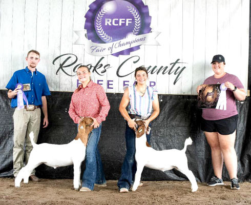BLAYKE STITHEM was the Grand Champion Meat Goat winner at the Rooks County Free Fair, as well as the Reserve Champion. She is pictured showing her Grand Champion Goat on the left with her cousin, Bodye Stithem, on the right. Also pictured are Judge Clay Elliott and Caitlin Hammond.