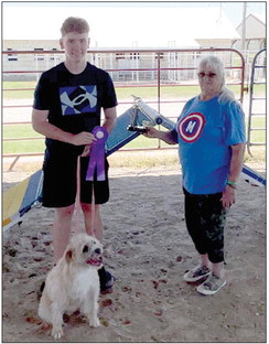 AT THIS YEAR’S ROOKS COUNTY FREE FAIR, Christian Miller and Grover of Gorham received the “Overall Agility III Champion” trophy in honor of his little brother, Malachi Miller. Kathy Creighton (right) sponsored the trophy, and was pleased to present it to Christian, knowing his late brother would have been so proud.