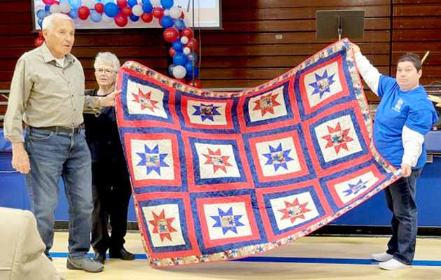 RECEIVING HIS QUILT OF VALOR made especially for him by Diane Maddy and Bev Glassman was Bob Hamilton (Army) at the Veterans Day program held at Stockton High School. Pictured are Bob Hamilton, Diane Maddy and Dena Bouchey.