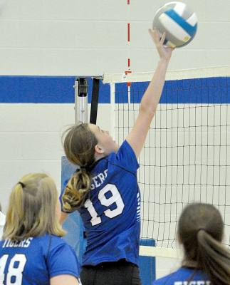 BROOKLYN COUSE, a sixth grader, tips the ball over the net vs. Ellis.