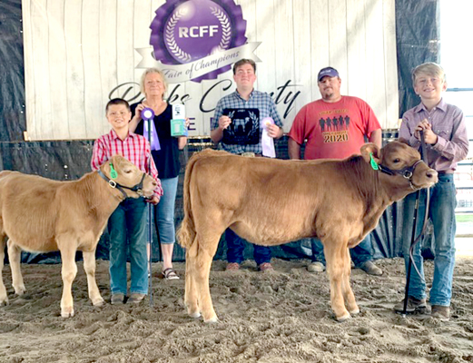BRODY AXELSON (left) showed this year's Rooks County Free Fair Grand Champion Bucket Calf, and Chance Zeigler (far right) had the Reserve Champion Bucket Calf. Brody Axelson, Kathy Dix, judge Logan Burham, Jeff Keller, and Chance Zeigler are pictured from left to right.
