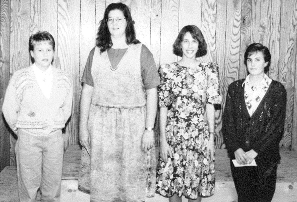 GOLD PIN WITH GOLD GUARD were awarded to four 4-H members attending the banquet in the fall of 1991. Pictured from left are Lisa Mongeau, Marissa Haines, Raina Jakoplic, and Becky Poore.