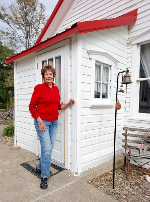 JOAN BALDERSTON stands by the one-room schoolhouse she attended in the late 1930s and early 1940s. She gave a presentation to the Stockton three- and four-year-old classes about what life was like growing up almost a century ago.
