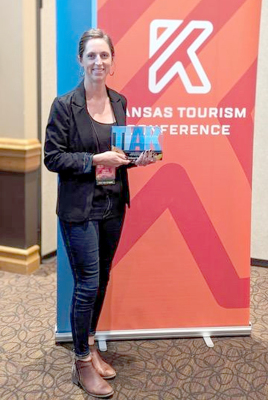 LISSA SEXSON is pictured at the Kansas Tourism Conference in Dodge City with the First Place Marketing Award in the Visitor Guide Category for its 2023 Northwest Kansas Ultimate Travel Guide publication.