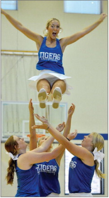 Cheerleaders Ella Snyder, Ava Dix, Karleigh Horn and Claire Plumer (in the air) at the Tiger Bash