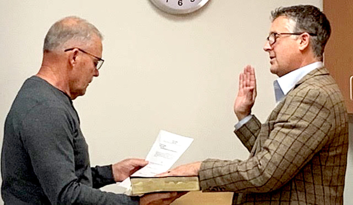 BRAD PLUMER (right) was sworn in as a new member of the Rooks County Health Center Board of Directors. Plumer replaces Dr. Michael Oller, M.D., who now serves as a medical consultant to the board. The board appreciates Dr. Oller for his years of service on the board and continued guidance. Brad and his wife, Daphne, of Stockton, have three daughters. Giving Brad the oath is President of the RCH Board of Directors, Jeff Van Dyke, left. (Courtesy Photo)